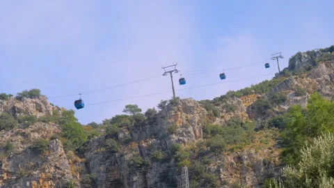 Ropeway, cable car cabins moving against cloudy sky over Mount Babadag, Turkey Stock-Footage 344992071