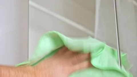 Ropped view man wiping mirror with rag, standing bathroom. Householder make Stock Footage 245657481