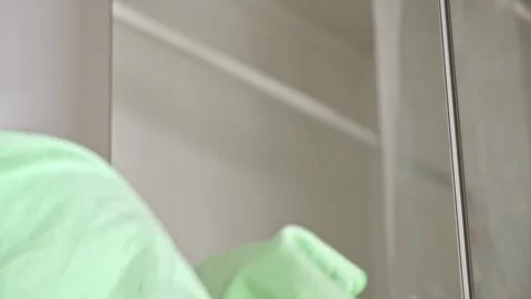 Ropped view man wiping mirror with rag, standing bathroom. Householder make Stock Footage 246915565