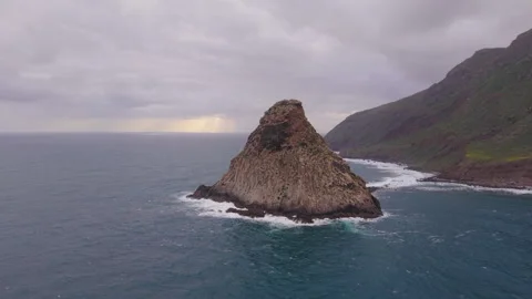 Roque de Tierra sea stack under stormy sky, Anaga, Tenerife Stock Footage 346883443