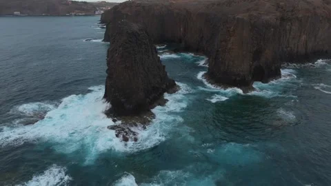 Roque del Farallon sea stack and cliffs with crashing waves, Gran Canaria Stock Footage 347516889