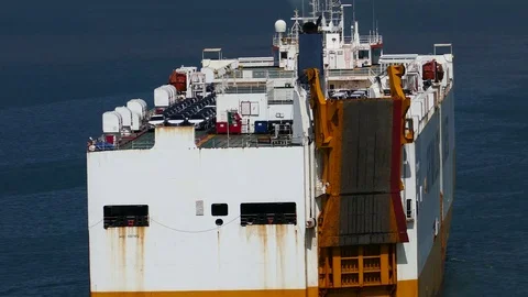 RoRo ship sails with new car lot on top aerial view 4k intro video for business Stock Footage 94555955
