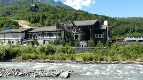 Rosa Khutor, Krasnodar Territory, 08.08.2021, Cable car across a mountain river Stock Footage 161237486