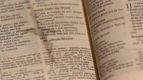 Rosary, cross shadow over an open bible Stock Footage 68570171