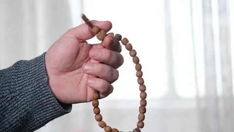 Rosary in a man's hand close-up. Prayer, meditation concept. Stock Footage 169100834