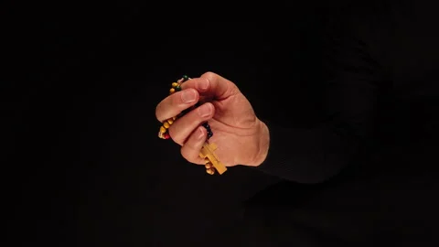 Rosary in a man's hand close-up. Prayer, meditation concept. Communion with God Stock Footage 224929006