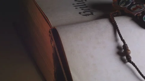 Rosary on an opened bible Stock Footage 55369760