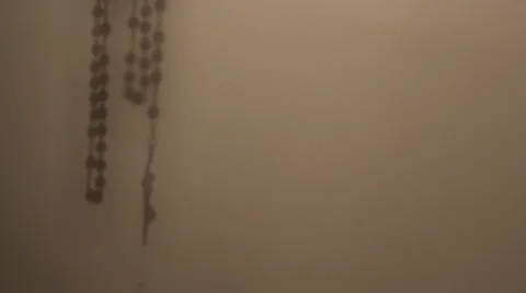 Rosary shadow on the wall Stock Footage 68570370