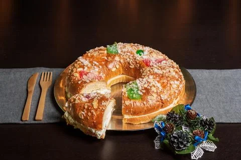 Roscn de reyes or king cake with a piece cut and separated from the roscon,.. Stock Photos