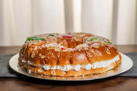 Roscon de reyes with candied fruit, almonds and sugar on top, filled with c.. Stock Photos