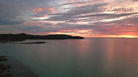 Rose candy floss clouds at sunset on beach. Wonderful aerial view flight drone Stock Footage 234009975
