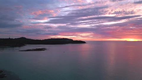 Rose colored cotton candy clouds sunset beach Beautiful aerial view flight drone Stock Footage 234010161