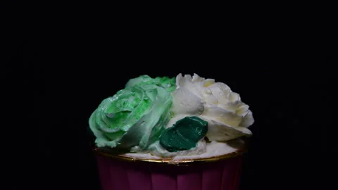 Rose cupcake rotation on black background. Stock Footage 306077315