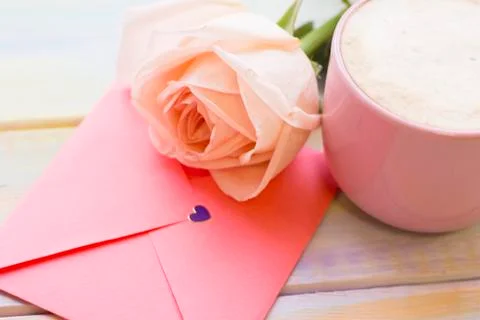 A rose, an envelope and coffee Foto stock