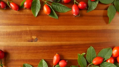 Rose hips with leaves on a board. Stock Footage 328592020