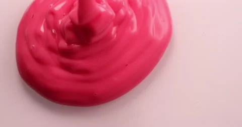 Rose liquid pourin on white surface in slow motion. Filmed with RED camera. Stock Footage 155403242
