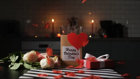 Rose petals fall on table with flowers and gifts Vídeos de archivo 327453679