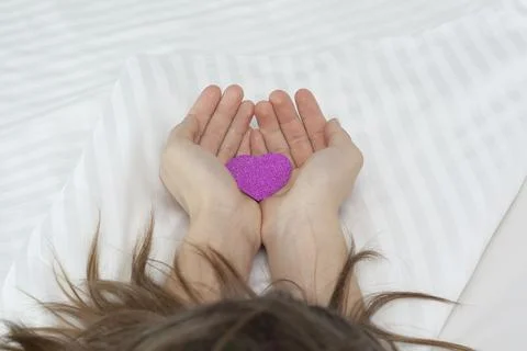 Rose petals in the hands on a white background. Heart in hand on Valentine's Day Stock Photos
