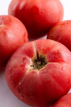 Rose tomatoes close up on white table. Autumn or summer harvest. fresh organic Stock Photos