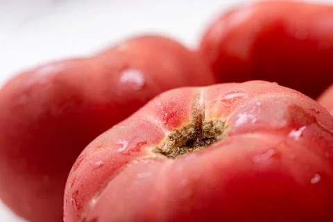 Rose tomatoes close up on white table. Autumn or summer harvest. fresh organic Stock Photos