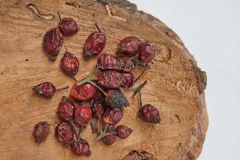 Rosehip berries on a wooden surface.Rose hip over old wooden background close Stock Photos