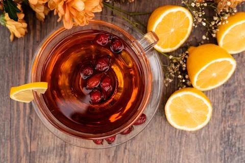 Rosehip tea with lemon in a clear cup. Autumn drink for colds Stock Photos