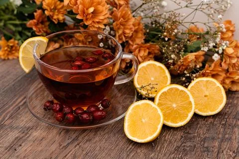 Rosehip tea with lemon in a clear cup. Autumn drink for colds Stock Photos