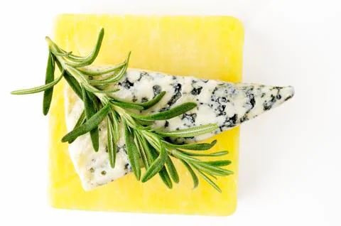 Rosemary on cheese Stock Photos