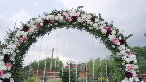 Roses on the arch in the boho style in cloudy day. Beautiful dark blue sky Stock Footage 219721131