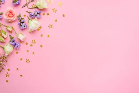 Roses, eustoma, limonium on pink background with spangled stars, flower compo Stock Photos