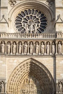Rosette and statues in front of Notre Dame cathedral in Paris Stock Photos