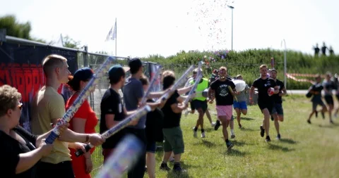 Roskilde, Denmark, 06/29/2019: Large crowd in confetti  with camping equipment Stock Footage 130153290
