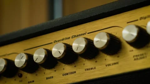 Rotary control knobs for volume, tone, and effects adjustment. Macro view of Stock-Footage 337640937