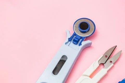 Rotary Cutter And Thread Snips On Pink Background Stock Photos