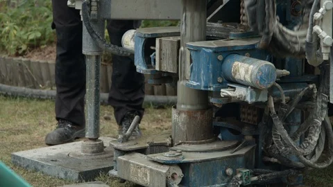 Rotary drill rig pulling out drill bit after drilling a groundwater borehole Stock Footage 123172389