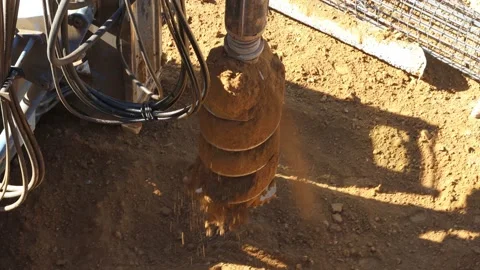 Rotary drilling rig machine empties out the soil Stock Footage 224681620