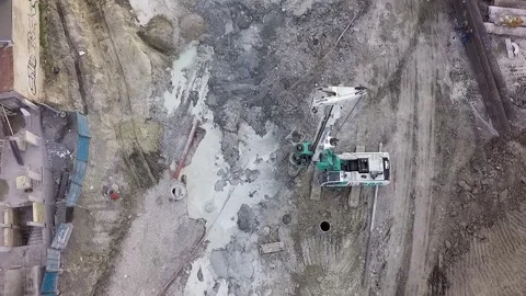 Rotary drilling rig machine working on a construction site aerial view Stock Footage 346410518