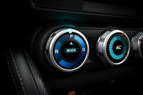 A rotary gear shift dial on the dashboard of an EV car or electric vehicle Stock Photos