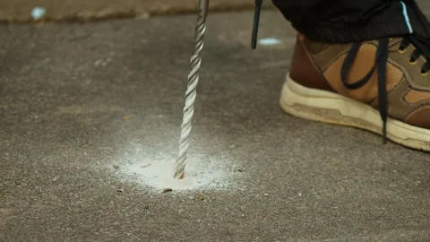 Rotary hammer working on concrete slab producing fine dust during hole formation Stock Footage 341569299