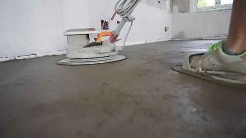 Rotary machine leveling concrete floor in construction project with piping un Video stock 302940602