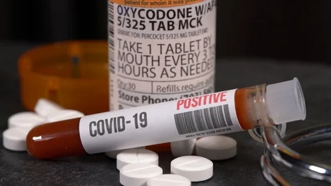 Rotate around generic oxycodone opioid tablet bottle with positive coronavirus Stock-Footage 127068968
