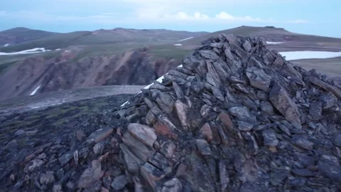Rotate around mountain peak pile of rocks and rising moon 動画素材 312032853