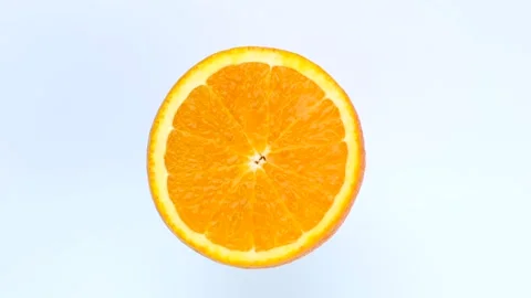 Rotate half orange isolated on white background Stock Footage 197001399