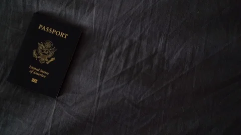 Rotate Left Looking Down at American Passport on Bed Stock Footage 96044514