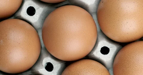 Rotate shot close up of the raw chicken eggs pattern on egg panel Stock Footage 136119979