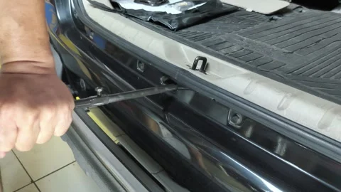 Rotate the winch to remove the spare tire from the storage area under the r.. Stock Footage 330470222