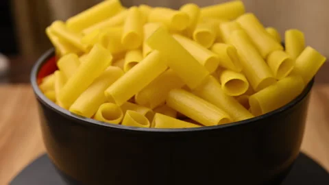 Rotate Yellow Raw Nalli Pipe Fryums In Bowl Top View Uncooked Snack Ingredient Stock Footage 325856142