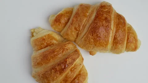 Rotated Croissants On White Background. Stock-Footage 248403486