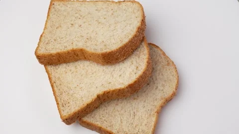 Rotated Whole Wheat Bread On White. Vídeo Stock 247097517