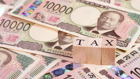 Rotating 10,000 yen bills and "TAX" block Stock Footage 303251353